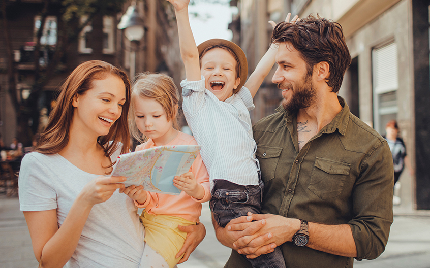 Smiling family on a city street.